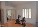 Bright bedroom with wood floors and mirrored closet doors, complemented by a stationary bicycle at 11290 N 117Th St, Scottsdale, AZ 85259