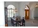 Elegant dining room with a large wooden table, upholstered chairs, and a chandelier at 11290 N 117Th St, Scottsdale, AZ 85259