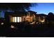 Beautiful single-story home illuminated at night features manicured landscaping and a tile roof at 11290 N 117Th St, Scottsdale, AZ 85259