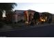 Beautiful single-story home at dusk with decorative lighting, a tile roof, and manicured landscaping at 11290 N 117Th St, Scottsdale, AZ 85259