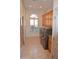 Convenient laundry room with updated appliances, built-in cabinetry, and natural light from the window at 11290 N 117Th St, Scottsdale, AZ 85259