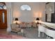 Elegant living room featuring a white piano, columns, a large arched window, and stylish decor at 11290 N 117Th St, Scottsdale, AZ 85259