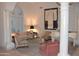 Bright living room boasts columns, a white piano, stylish furniture, and an arched window at 11290 N 117Th St, Scottsdale, AZ 85259