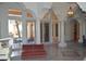 Spacious room features columns, a white piano, and glass doors leading to an outdoor patio and a grill at 11290 N 117Th St, Scottsdale, AZ 85259