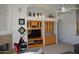 Living room with a fireplace, decorative wall shelving, and an arched ceiling fan above at 11290 N 117Th St, Scottsdale, AZ 85259