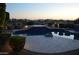Backyard pool with elevated spa, rock landscaping, and mountain views at sunset at 11290 N 117Th St, Scottsdale, AZ 85259