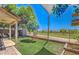 Manicured backyard featuring a green lawn, mature trees, and views of the community at 1212 S Boulder St # C, Gilbert, AZ 85296