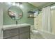 Bathroom featuring a vanity, toilet, round mirror, and shower-tub combination at 1212 S Boulder St # C, Gilbert, AZ 85296