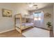 Bright bedroom featuring a bunk bed, a window, wood floors and a white rug at 1212 S Boulder St # C, Gilbert, AZ 85296