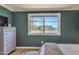 Main bedroom with a dresser and a window providing a view of the outdoors at 1212 S Boulder St # C, Gilbert, AZ 85296