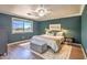 Well-lit main bedroom showcasing a comfortable bed, elegant decor, and ample natural light at 1212 S Boulder St # C, Gilbert, AZ 85296