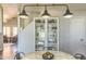 Cozy dining area with stylish lighting fixture, marble table, and a view into the living space at 1212 S Boulder St # C, Gilbert, AZ 85296