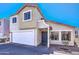 Two-story home featuring a two-car garage and a charming blue front door at 1212 S Boulder St # C, Gilbert, AZ 85296