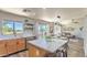 Open kitchen features an island, stainless steel appliances and a view of the living room at 1212 S Boulder St # C, Gilbert, AZ 85296