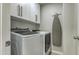 Laundry room with large white washer and dryer and overhead cabinets at 1212 S Boulder St # C, Gilbert, AZ 85296