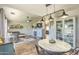 Open-concept living room with fireplace, ceiling fan, and view into the dining area at 1212 S Boulder St # C, Gilbert, AZ 85296