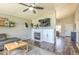 Inviting living room features a fireplace, dark wood floors, ceiling fan, and neutral wall color at 1212 S Boulder St # C, Gilbert, AZ 85296