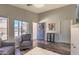 Comfortable living room boasts natural light from windows and a welcoming blue front door at 1212 S Boulder St # C, Gilbert, AZ 85296