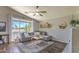 Bright living room features a comfortable couch, ceiling fan, and a view of the outdoors at 1212 S Boulder St # C, Gilbert, AZ 85296