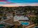 Aerial view of backyard oasis with large pool and mountain views at sunset at 14830 N 28Th Pl, Phoenix, AZ 85032