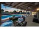 Outdoor pool area featuring a covered patio, lush landscaping, and ample seating space at 14830 N 28Th Pl, Phoenix, AZ 85032