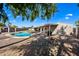 Backyard with a refreshing pool, shaded by mature trees, offers a private and serene retreat at 14830 N 28Th Pl, Phoenix, AZ 85032