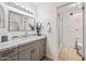 Bathroom with gray vanity and tiled shower at 14830 N 28Th Pl, Phoenix, AZ 85032