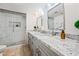 Bathroom with modern double vanity, granite countertop, and glass enclosed shower at 14830 N 28Th Pl, Phoenix, AZ 85032