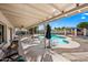 Relaxing covered patio overlooking a beautiful pool and backyard, perfect for outdoor dining and entertaining at 14830 N 28Th Pl, Phoenix, AZ 85032