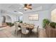 Dining room features tile floors, a modern ceiling fan and views to the staged living room at 14830 N 28Th Pl, Phoenix, AZ 85032