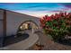 Inviting entryway with an arched walkway, desert landscaping, and views to the home's interior at 14830 N 28Th Pl, Phoenix, AZ 85032
