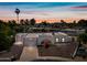 Charming home featuring desert landscaping, an arched entryway, and a two-car garage at sunset at 14830 N 28Th Pl, Phoenix, AZ 85032