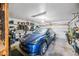 Organized garage with ample storage, a clean interior, and parking space for a modern electric car at 14830 N 28Th Pl, Phoenix, AZ 85032