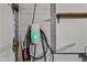 Electric vehicle charging station installed in garage with white brick walls and a storage shelf at 14830 N 28Th Pl, Phoenix, AZ 85032