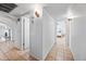 Hallway view with neutral tiling and access to multiple rooms at 14830 N 28Th Pl, Phoenix, AZ 85032
