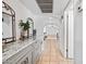 Hallway with unique architectural arches and grey cabinetry at 14830 N 28Th Pl, Phoenix, AZ 85032