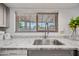 Close-up on kitchen sink area highlighting granite counters and a modern faucet by a bright window at 14830 N 28Th Pl, Phoenix, AZ 85032