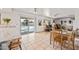 Bright open-concept kitchen and dining area featuring a view of the pool through sliding doors at 14830 N 28Th Pl, Phoenix, AZ 85032