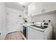 Laundry room featuring white cabinetry and modern washer and dryer at 14830 N 28Th Pl, Phoenix, AZ 85032
