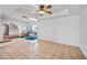 Bright living room featuring tile flooring, a ceiling fan, and an open design to the outdoor living space at 14830 N 28Th Pl, Phoenix, AZ 85032