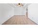 Minimalist living area with tile floors and an open concept, leading to the kitchen with neutral decor at 14830 N 28Th Pl, Phoenix, AZ 85032