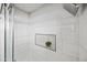 Detailed view of the shower with tiled walls and corner shelving at 14830 N 28Th Pl, Phoenix, AZ 85032