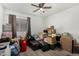 Bedroom showing storage boxes, a ceiling fan, a window and horizontal blinds at 16160 W Custer Ln, Surprise, AZ 85379