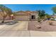 Inviting single-story home with a two-car garage, low maintenance landscaping, and desert rock at 16160 W Custer Ln, Surprise, AZ 85379