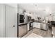 Well-lit kitchen featuring stainless steel appliances, a modern refrigerator, and ample cabinet space at 16160 W Custer Ln, Surprise, AZ 85379