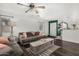 Cozy living room showcasing hardwood floors, comfortable seating, and views into the kitchen at 16160 W Custer Ln, Surprise, AZ 85379