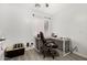 Minimalist home office featuring desk, office chair, and neutral decor with a bright window at 16160 W Custer Ln, Surprise, AZ 85379