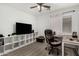 Functional home office setup with desk, office chair, storage shelves, and natural light at 16160 W Custer Ln, Surprise, AZ 85379