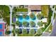 Aerial view of the sparkling community pool surrounded by palm trees, lounge chairs, and lush landscaping at 1771 E Alegria Rd, Queen Creek, AZ 85140