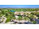 Stunning aerial view of the community clubhouse, nestled amid a lush green golf course and towering palm trees at 1771 E Alegria Rd, Queen Creek, AZ 85140